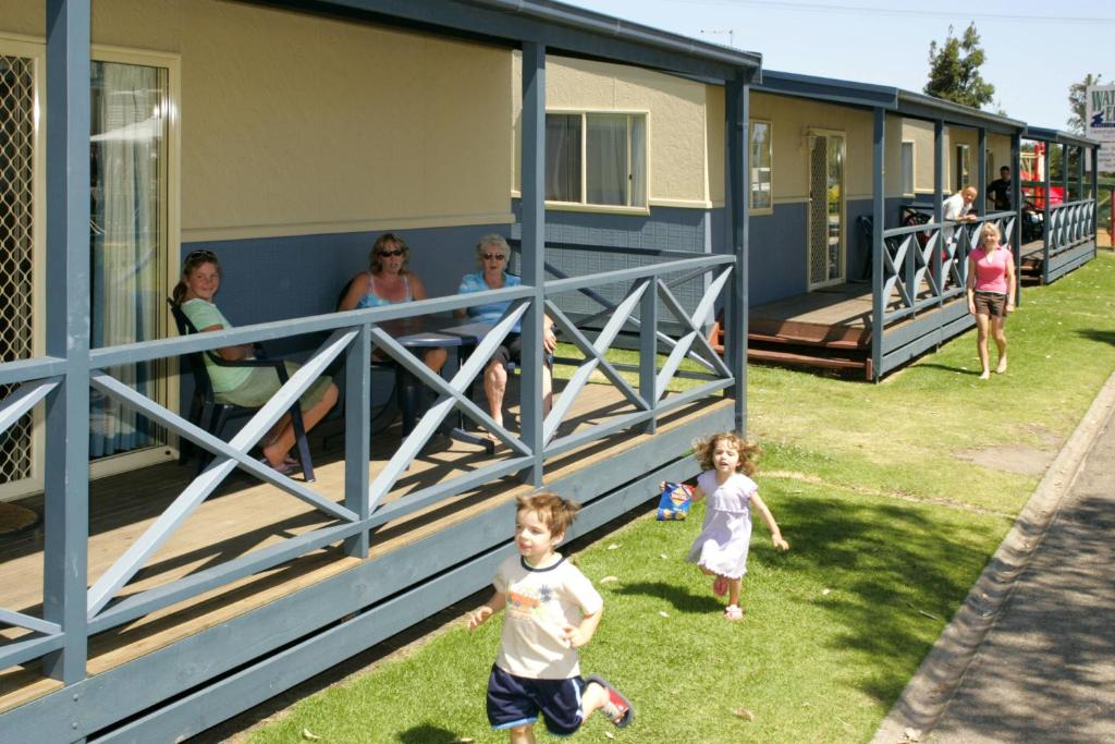 a group of people walking outside of a house at BIG4 Waters Edge Holiday Park in Lakes Entrance