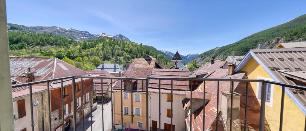 a view of a town with mountains in the background at Hotel Pascal in Allos