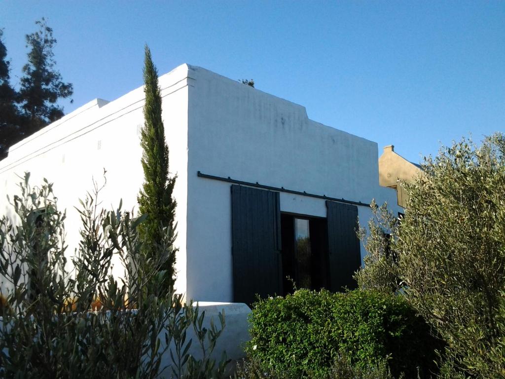 a white building with a black door at The Barn, McGregor in McGregor