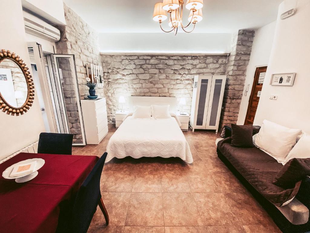um quarto de hotel com uma cama e um sofá em Guesthouse Antonio em Alicante
