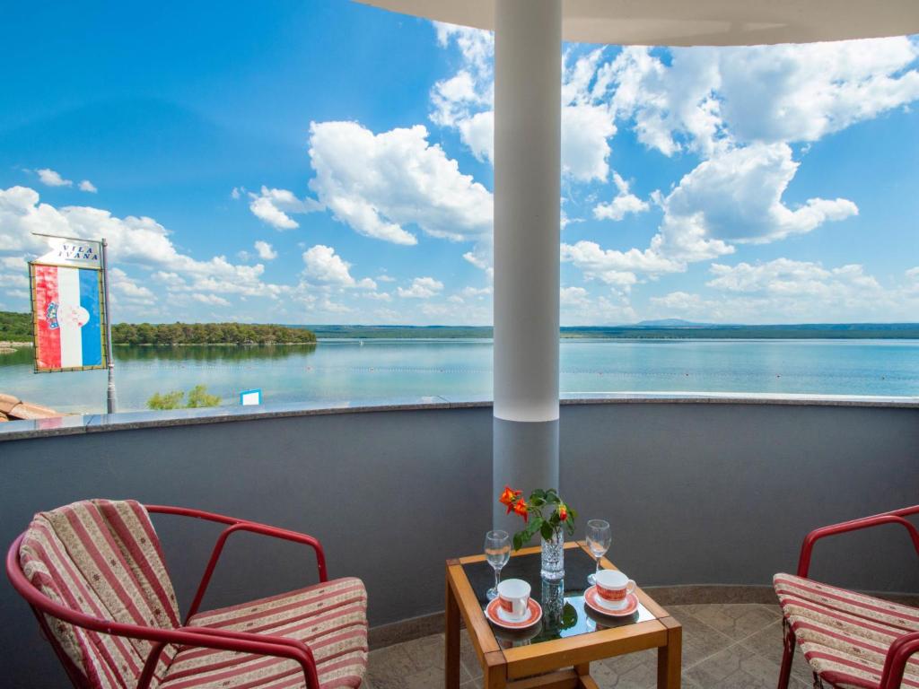 a balcony with chairs and a view of the water at Apartment Ivana-3 by Interhome in Raslina