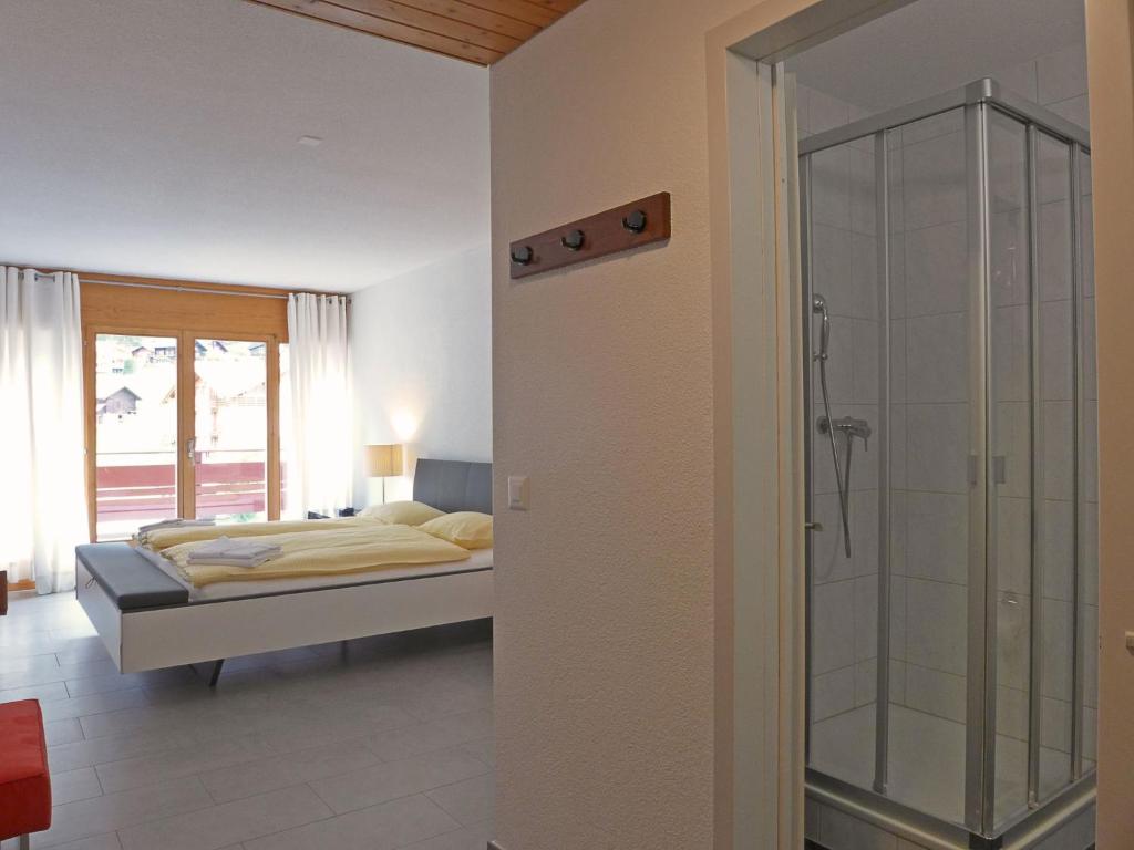 Postel nebo postele na pokoji v ubytování Apartment Eiger Residence Apt-H by Interhome