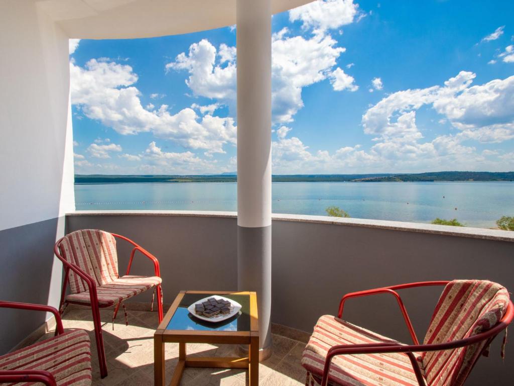 a balcony with chairs and a view of the water at Apartment Ivana-2 by Interhome in Raslina