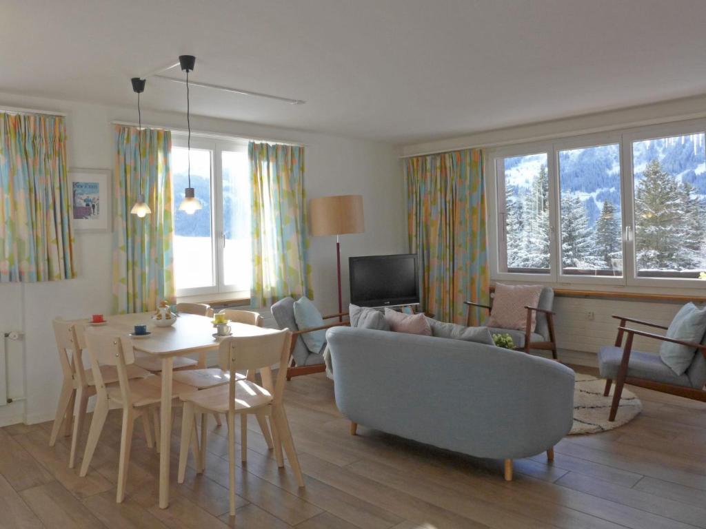 a living room with a couch and a table at Apartment Tschingelhorn by Interhome in Wengen