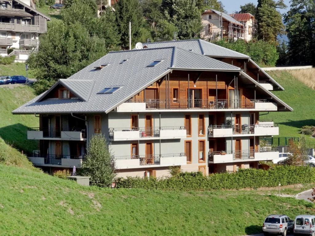 a house with a solar roof on a hill at Apartment Le Clos de la Fontaine-1 by Interhome in Saint-Gervais-les-Bains