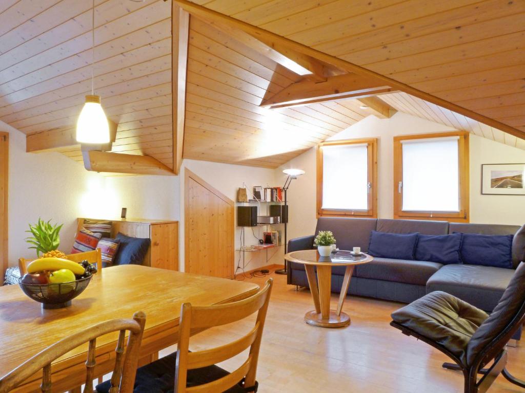 a living room with a couch and a table at Apartment Melodie by Interhome in Wengen