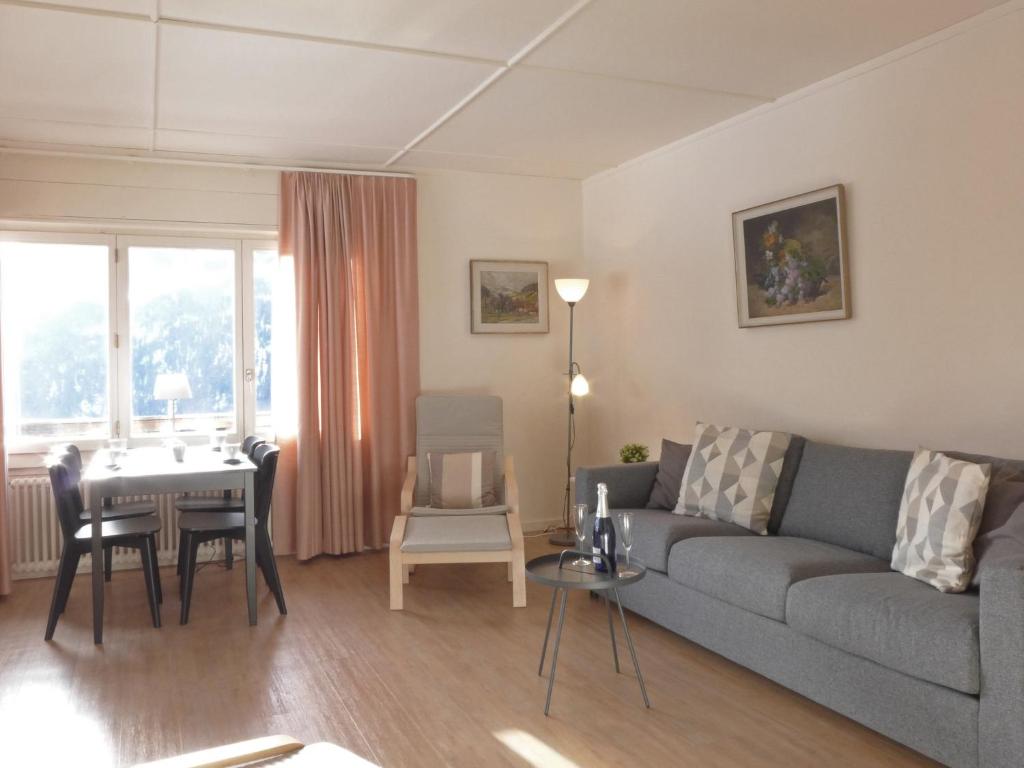 a living room with a couch and a table at Apartment Helene Apt-Diana by Interhome in Wengen