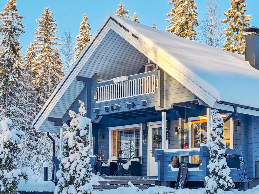 a blue house with a balcony in the snow at Holiday Home Willa klaara by Interhome in Patajoki