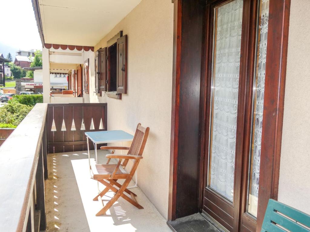 a table and chairs on the balcony of a house at Apartment Les Jardins Alpins-4 by Interhome in Saint-Gervais-les-Bains