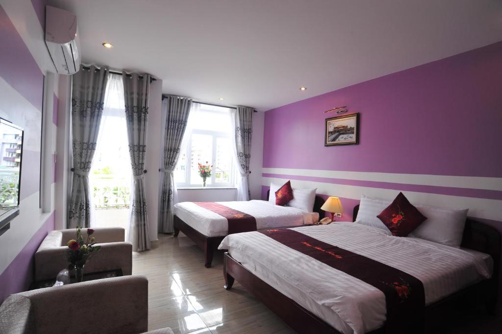 Postel nebo postele na pokoji v ubytování Hong Thien Ruby Hotel