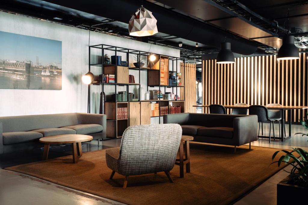 a living room with couches and chairs and a table at Good Hotel London in London