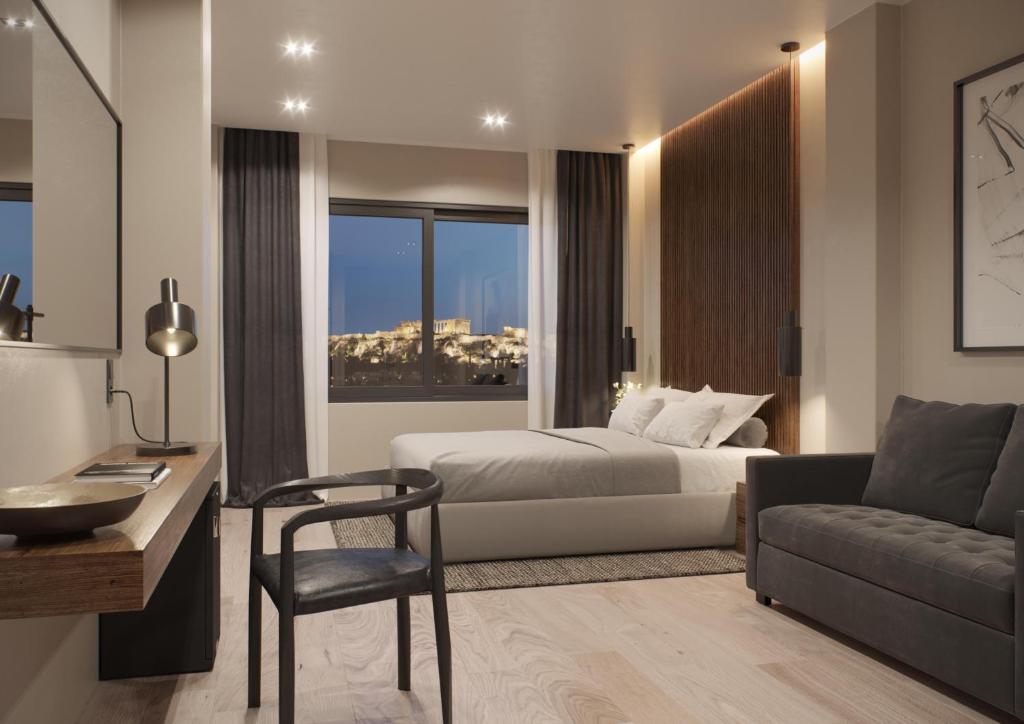 una camera con letto, scrivania e divano di Athens Tower Hotel by Palladian Hotels ad Atene