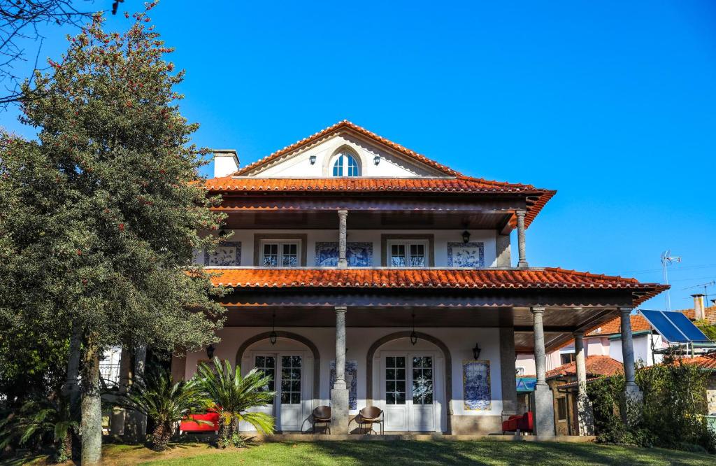 a large white house with a red roof at Quinta do Candeeira in Santa Maria Da Feira