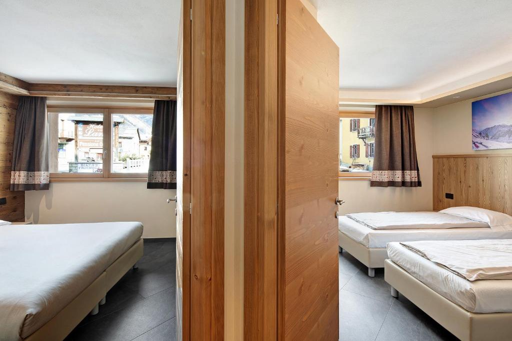 Posteľ alebo postele v izbe v ubytovaní Rasia Residence Relax Lake