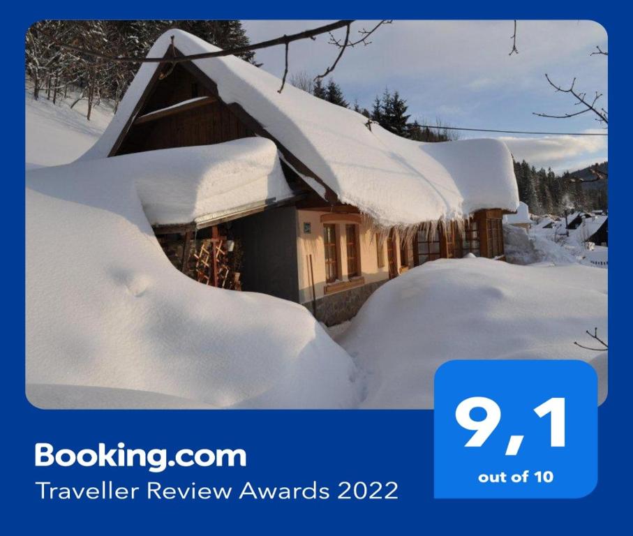 a house covered in snow with the wordskeellingivan review awards at Chalupa Ferka Pavlíka in Donovaly