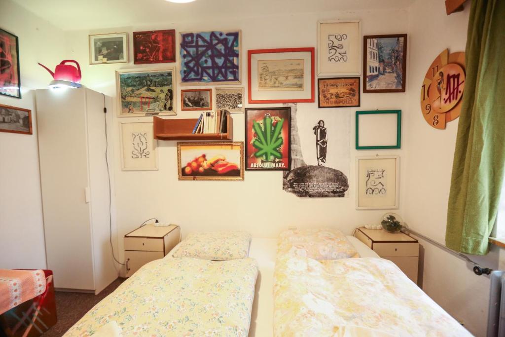 two beds in a room with pictures on the wall at Hostel KlonDike in Pec pod Sněžkou