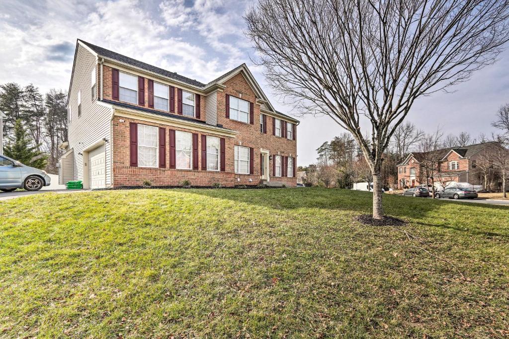 a large brick house with a tree in the yard at Laurel Family Home with Updates and Easy Location! in Laurel
