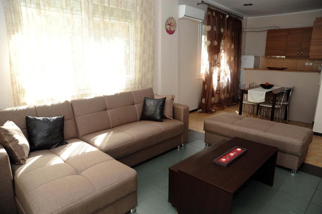 a living room with a couch and a table at Kavala's central apartment in Kavála