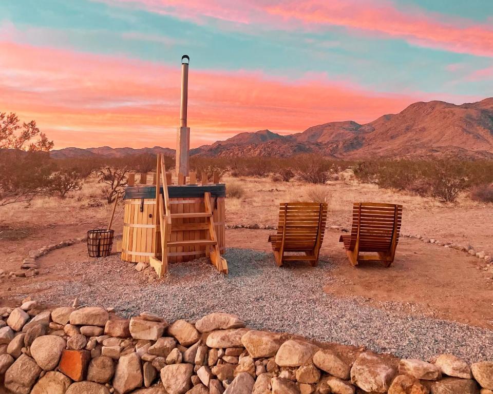 two chairs and a table in the desert at 1 Minute To Joshua Tree National Park, Hot Tub, Stars, Private - The WKNDR in Twentynine Palms