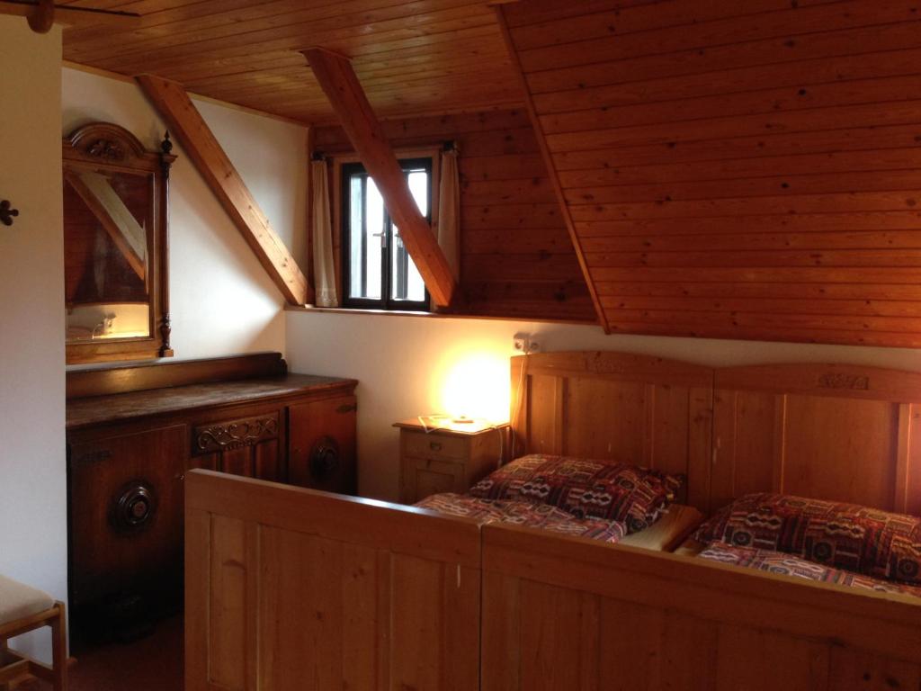 a bedroom with two beds in a wooden cabin at Yveta - Depandance Horské Zátiší in Horni Misecky