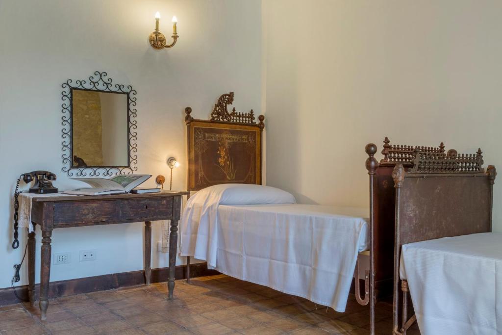 Postel nebo postele na pokoji v ubytování Masseria Fortificata Lo Zafferaneto