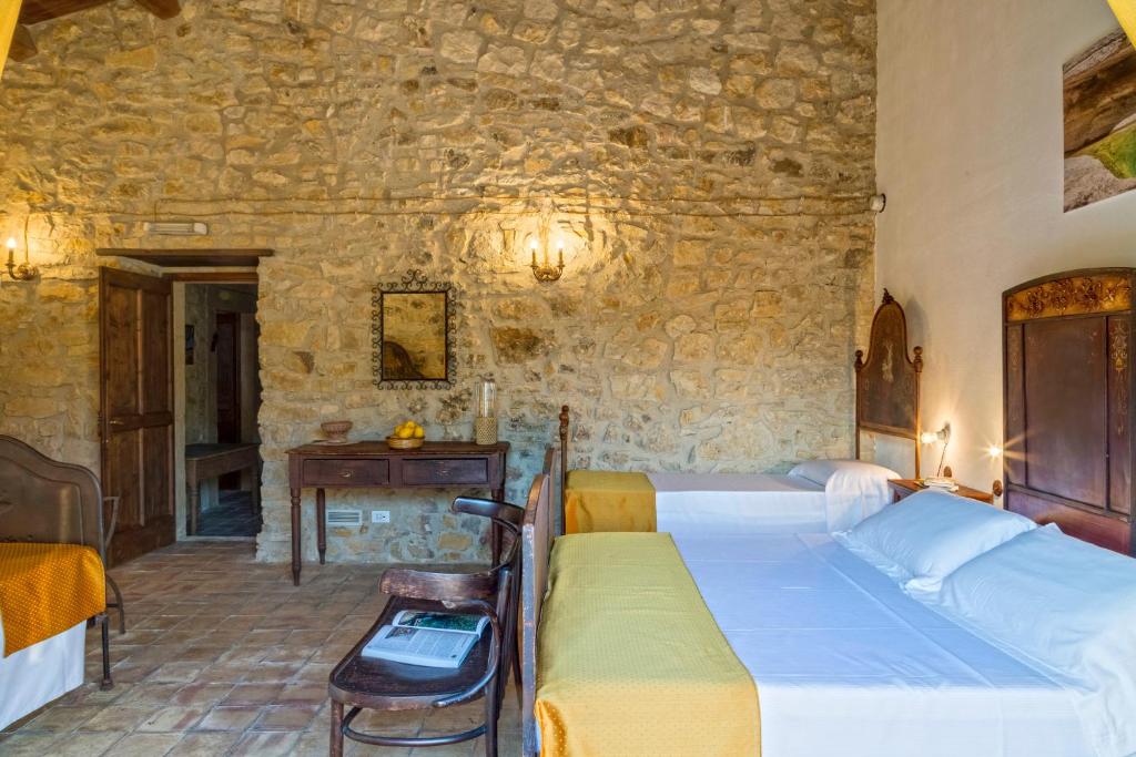 Postel nebo postele na pokoji v ubytování Masseria Fortificata Lo Zafferaneto
