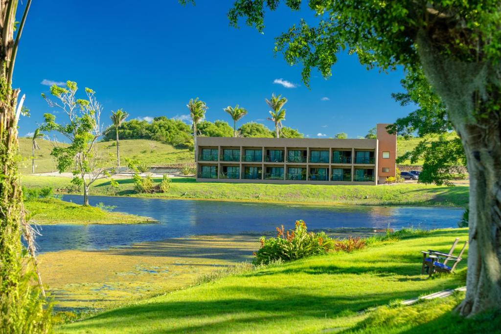 a building with a river in front of it at Reserva dos Lagos in Laranjeiras