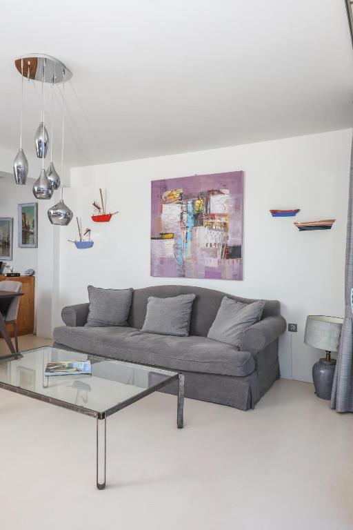 a living room with a couch and a glass table at Raise Spetses Sea View Villa in Spetses