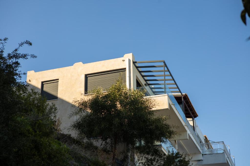 a building with a ladder on the side of it at Raise Spetses Sea View Villa in Spetses