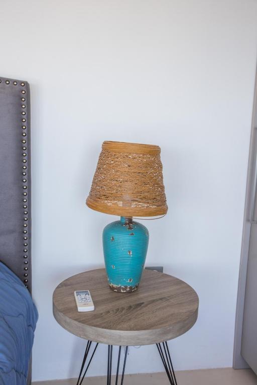 a blue lamp on a table with a lamp on it at Raise Spetses Sea View Villa in Spetses