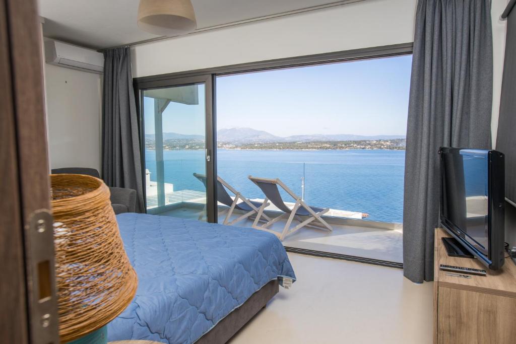 a bedroom with a bed and a view of the ocean at Raise Spetses Sea View Villa in Spetses