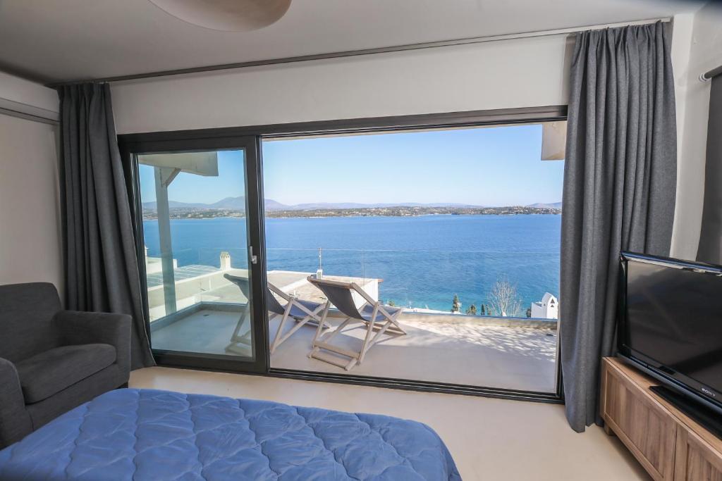a bedroom with a view of the ocean at Raise Spetses Sea View Villa in Spetses