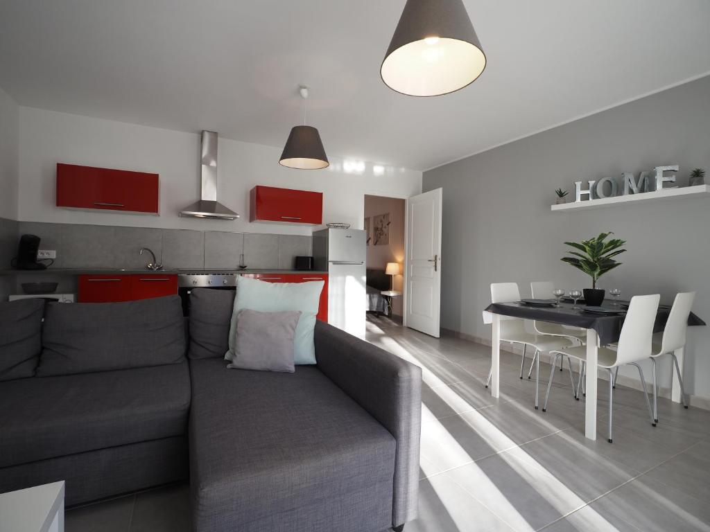 uma sala de estar com um sofá, uma mesa e uma cozinha em Appartement dans le verdon em Allemagne-en-Provence