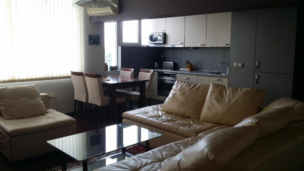 a living room with a couch and a table at Apartment Dima in Varna City