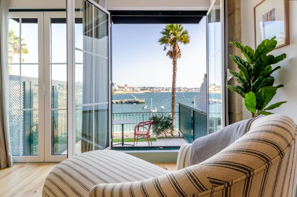 a living room with a couch and a view of the water at Westlight Cascais Chalet - Adults Only in Cascais