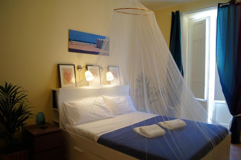 a bedroom with a bed with two towels on it at La Fabbrica del Viceré in Palermo