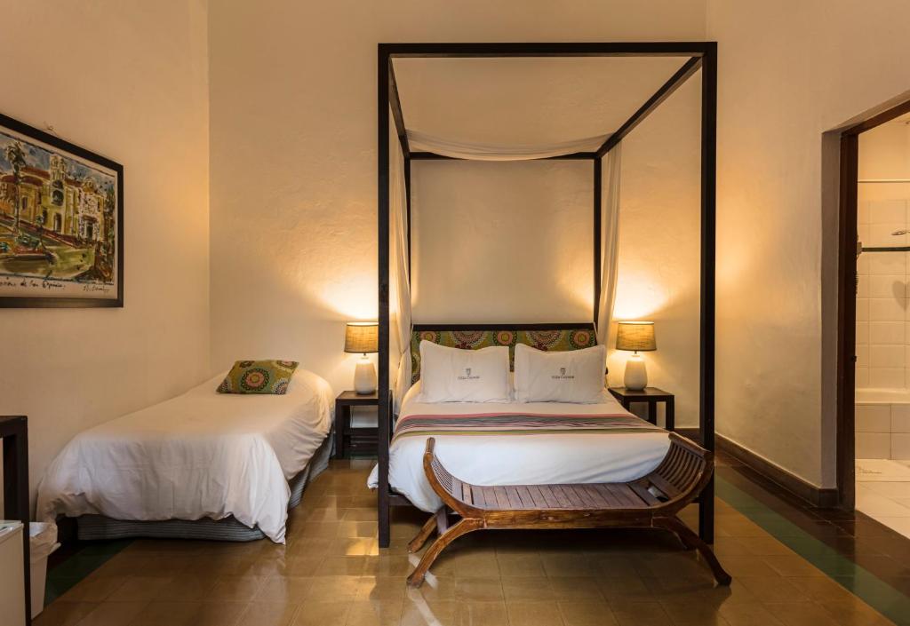 Postel nebo postele na pokoji v ubytování Hotel Villa Colonial