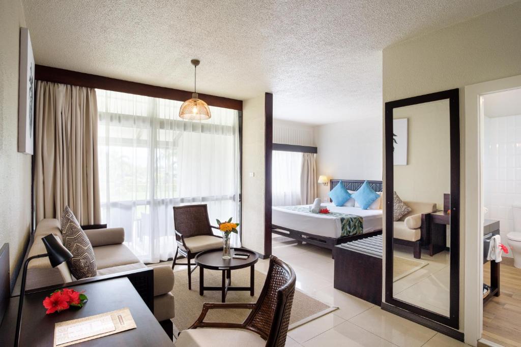 a room with a living room and a bedroom at Fiji Gateway Hotel in Nadi