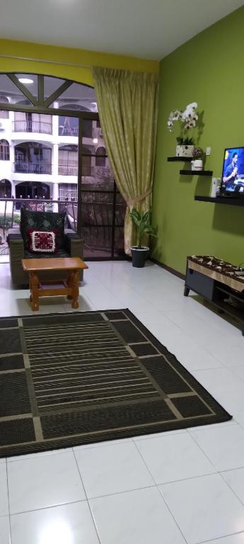 a living room with a couch and a table at ROSSA HOLIDAY APARTMENT in Kuah