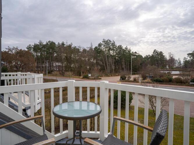 a white railing with a table on a balcony at Apartment in St Peter-Ording in Süderhöft