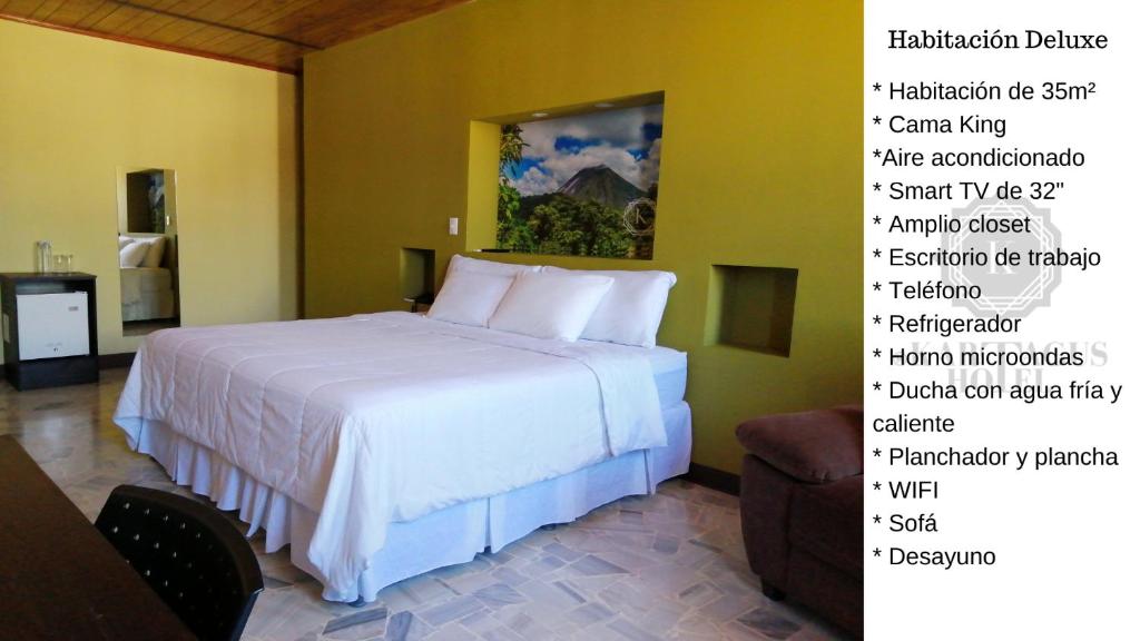 a bedroom with a bed and a wall with different names at Kartagus Hotel in San Salvador