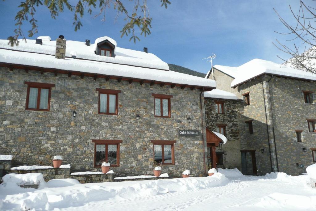 ein großes Steingebäude mit Schnee um ihn herum in der Unterkunft Hostal Pernalle in Erill la Vall