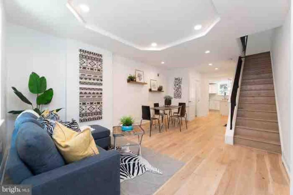 a living room with a blue couch and a table at Brand new home in South Philly!!! in Philadelphia