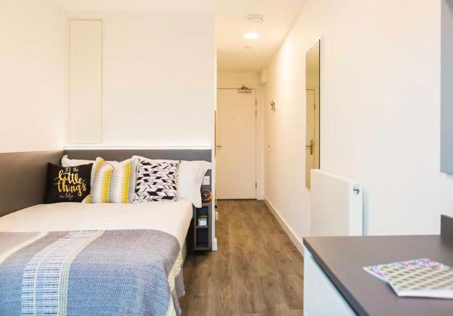 a small bedroom with a bed and a desk at Student/one person accommodation flat in London