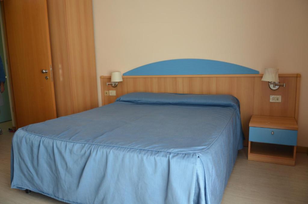 Postel nebo postele na pokoji v ubytování Hotel Lisa