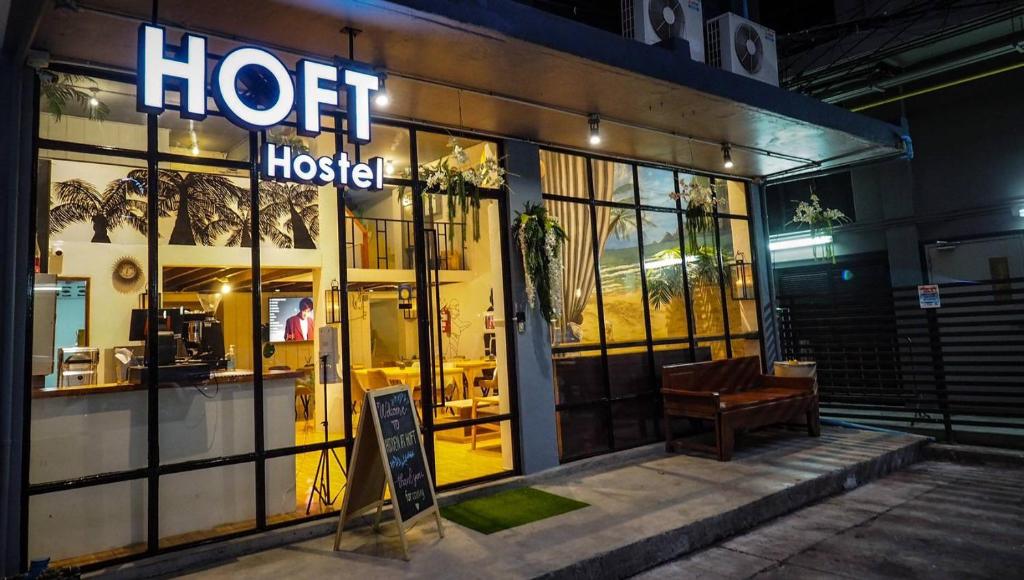 a store front of a hotel with a bench in front of it at Hoft Hostel Bangkok in Bangkok