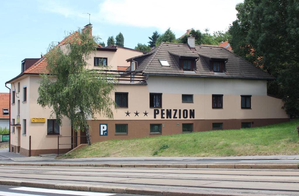 a building with a sign on the side of it at Penzion Chaloupka in Prague