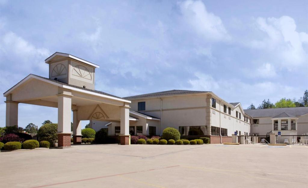 a building with a clock tower on top of it at Americas Best Value Inn Kilgore in Kilgore