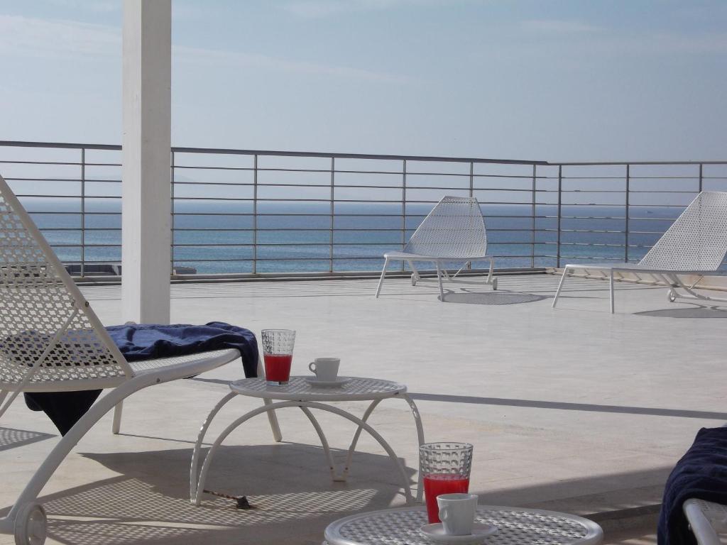 a person sitting in a chair on a balcony at Brezza Di Grecale in Trapani