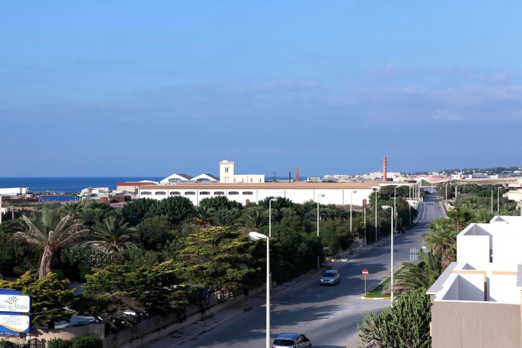 a city street with cars driving down a road at Brezza Di Grecale in Trapani